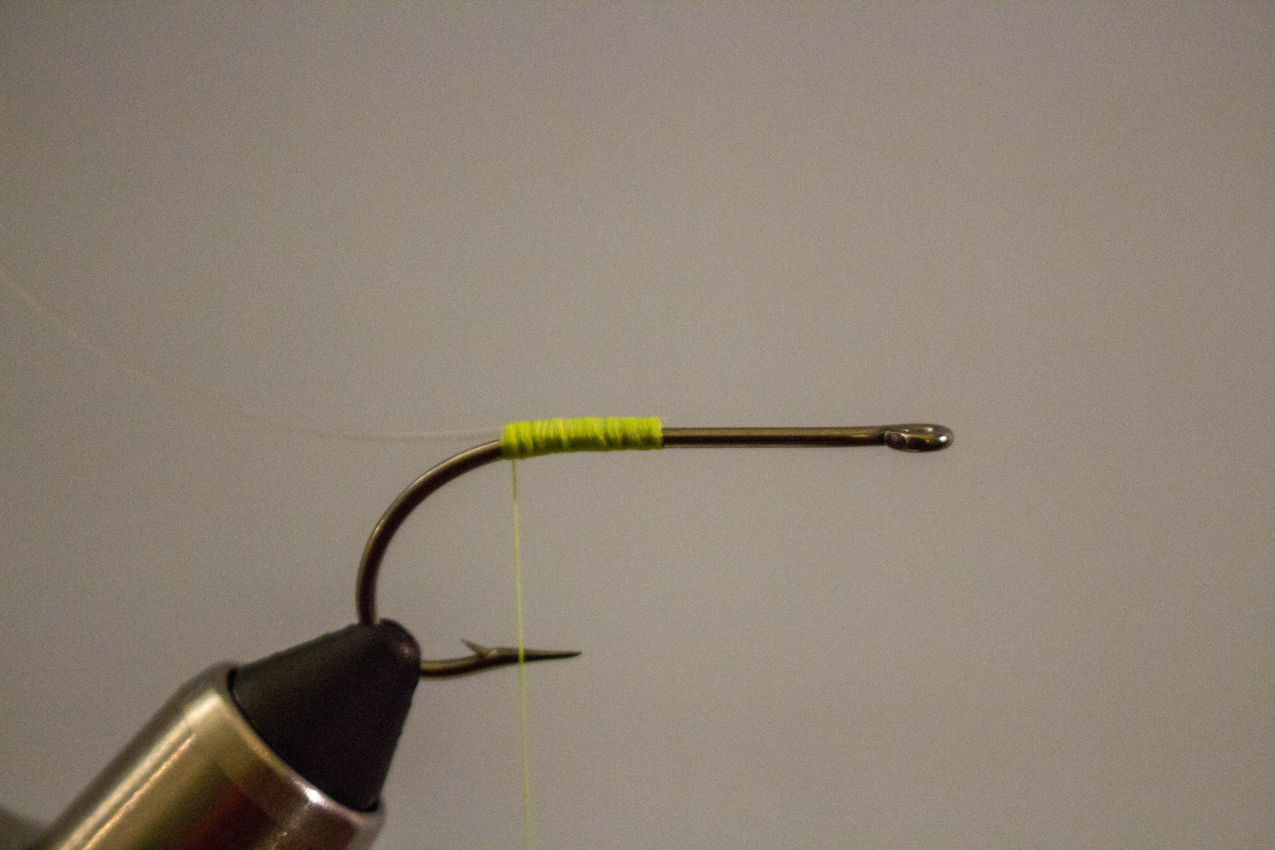 Tarpon Bunny - Step 2: Tie in a piece of monofilament at the bend of the hook as a…