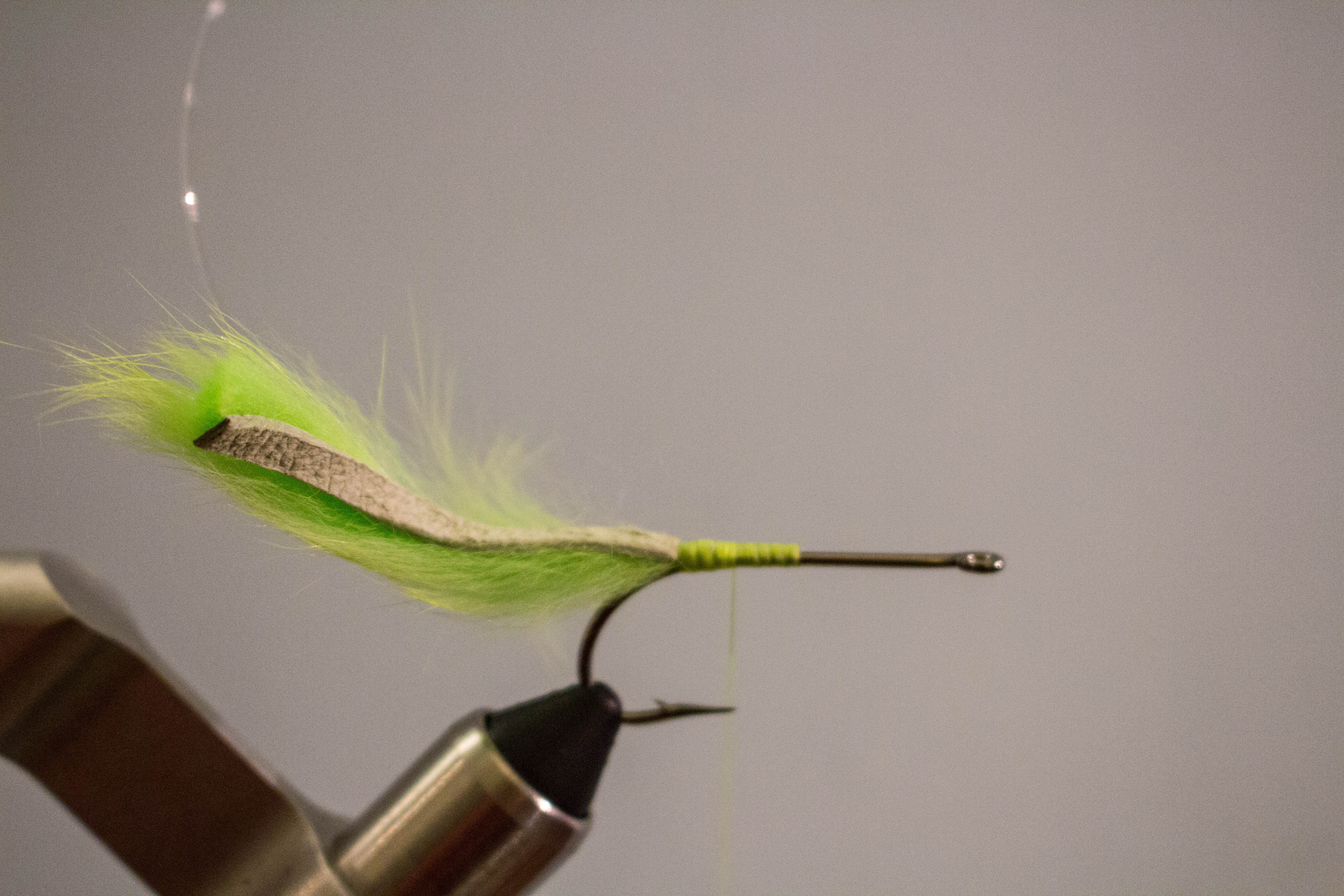 Tarpon Bunny - Step 3: Tie in a rabbit strip on top of the back of the hook shank …